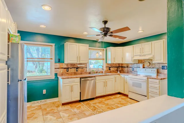 a view of an empty room with a window and fireplace