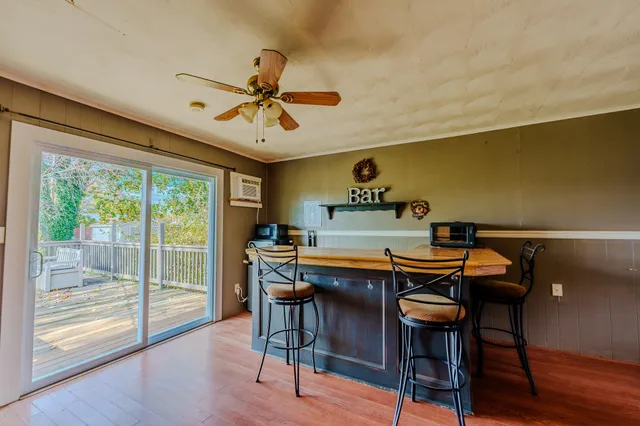 a view of a room with gym equipment and wooden floor