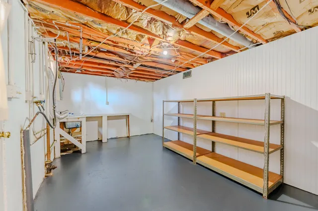 a view of a room with wooden floor and white walls