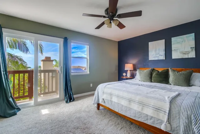 a bedroom with a large bed and a chandelier