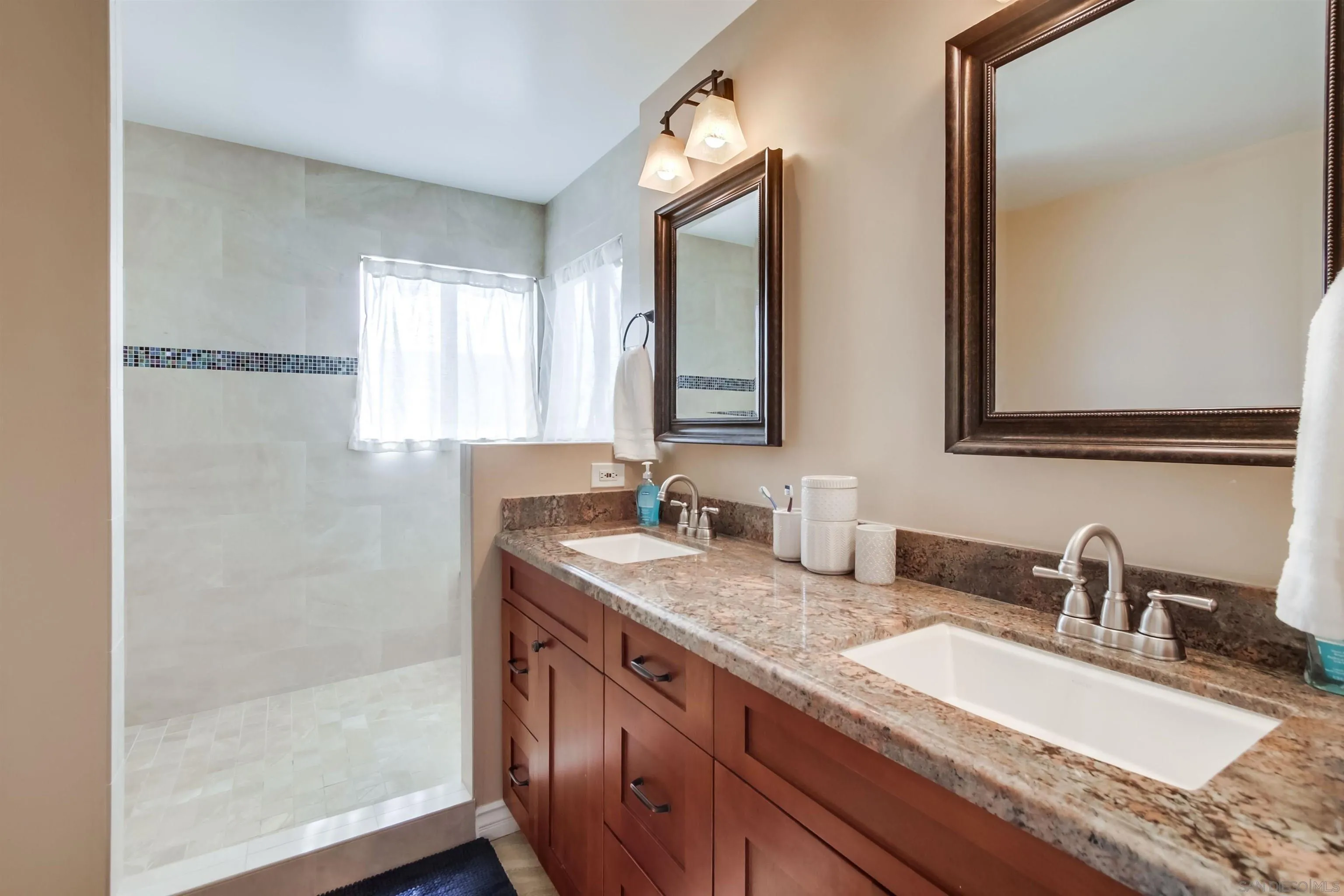 930 Gardena Road Encinitas, CA 92024 - Photo 15 of 27 a bathroom with double sink and a mirror