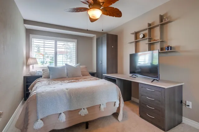 a bedroom with a bed and a flat screen tv