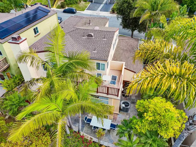 a view of a patio with a table and chairs and potted plants