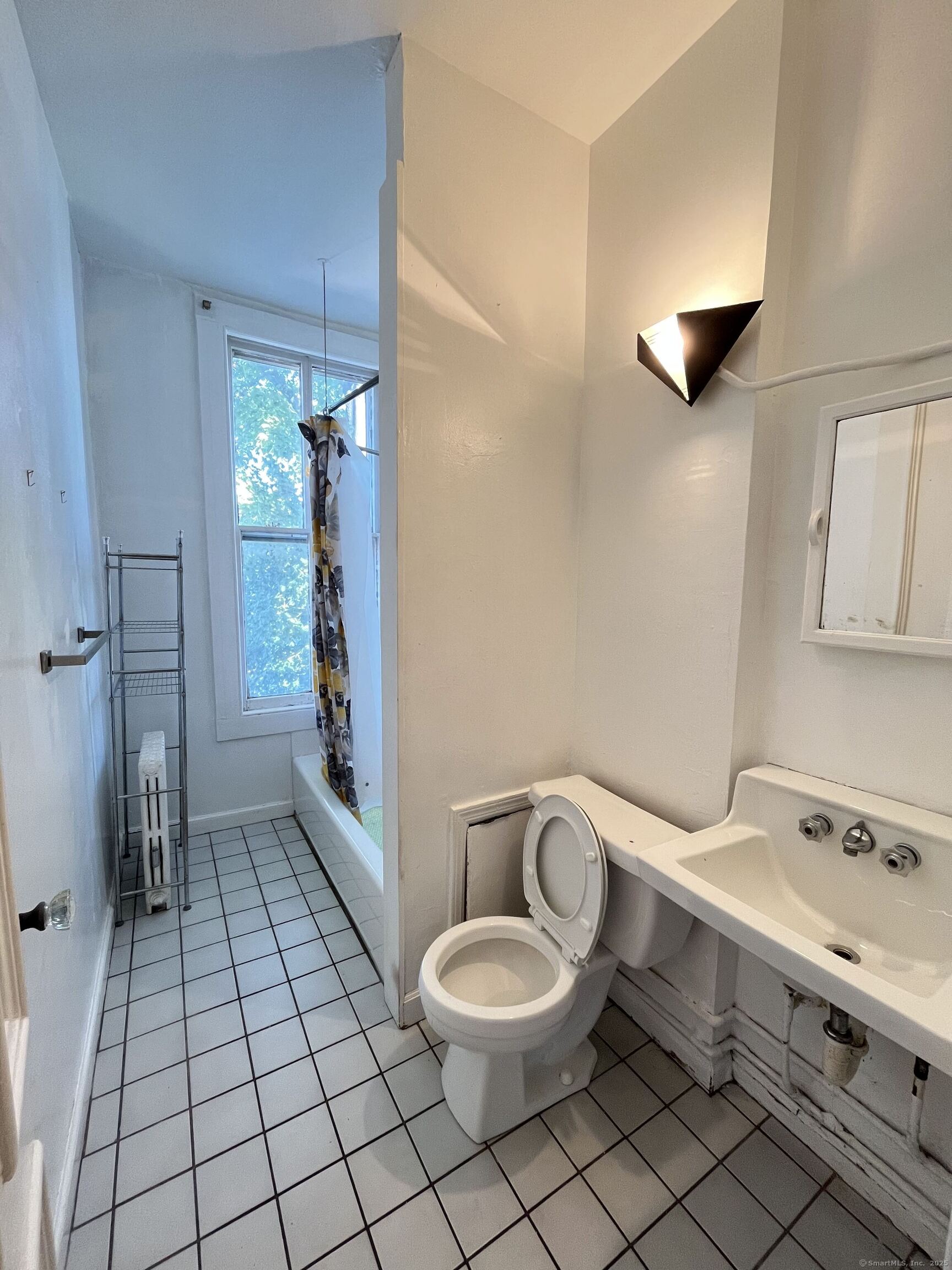 218 Flax Hill Road, Unit 4 Norwalk, CT 06854 - Photo 5 of 9 a bathroom with a toilet sink and mirror