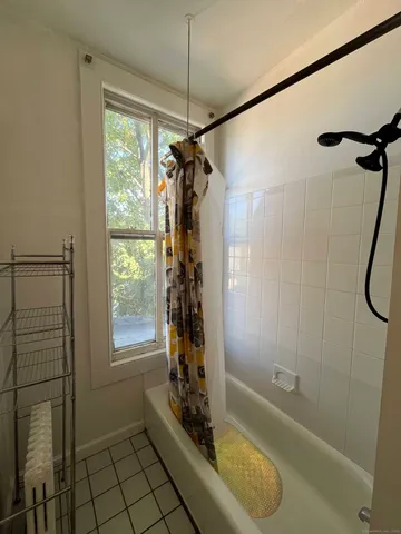 a bathroom with a shower and a bathtub