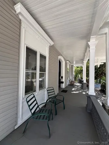 a balcony with furniture and a potted plant