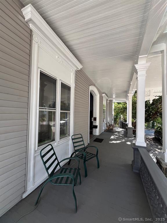 218 Flax Hill Road, Unit 4 Norwalk, CT 06854 - Photo 7 of 9 a balcony with furniture and a potted plant