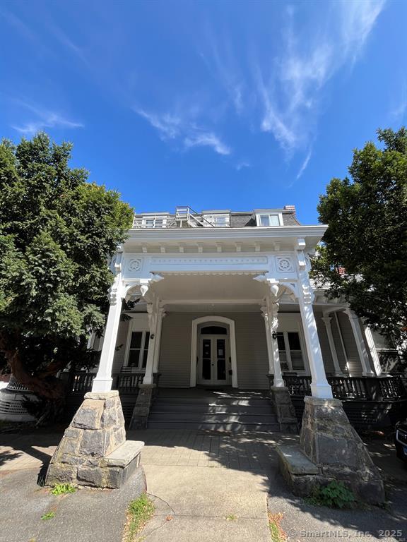 218 Flax Hill Road, Unit 4 Norwalk, CT 06854 - Photo 8 of 9 a front view of a house with a yard