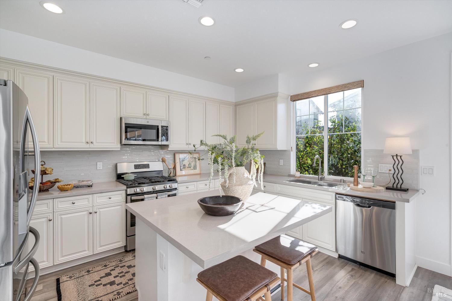 2560 Red Willow Drive Santa Rosa, CA 95403 - Photo 16 of 62 a kitchen with stainless steel appliances kitchen island granite countertop a sink a stove a dining table and chairs