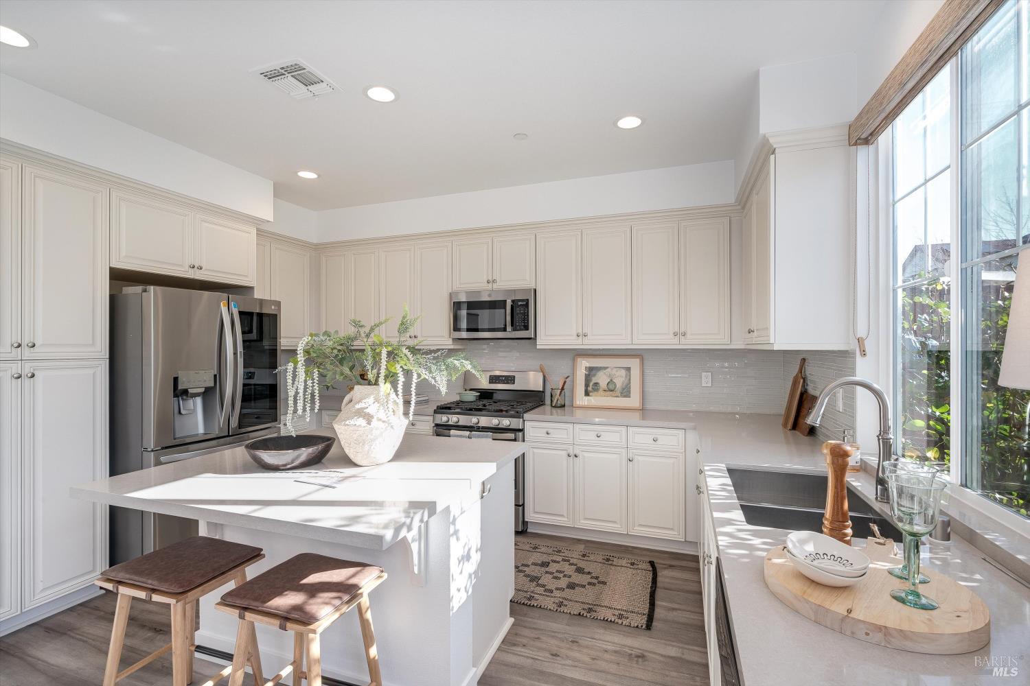 2560 Red Willow Drive Santa Rosa, CA 95403 - Photo 19 of 62 a kitchen with stainless steel appliances granite countertop a sink a stove a refrigerator cabinets and chairs