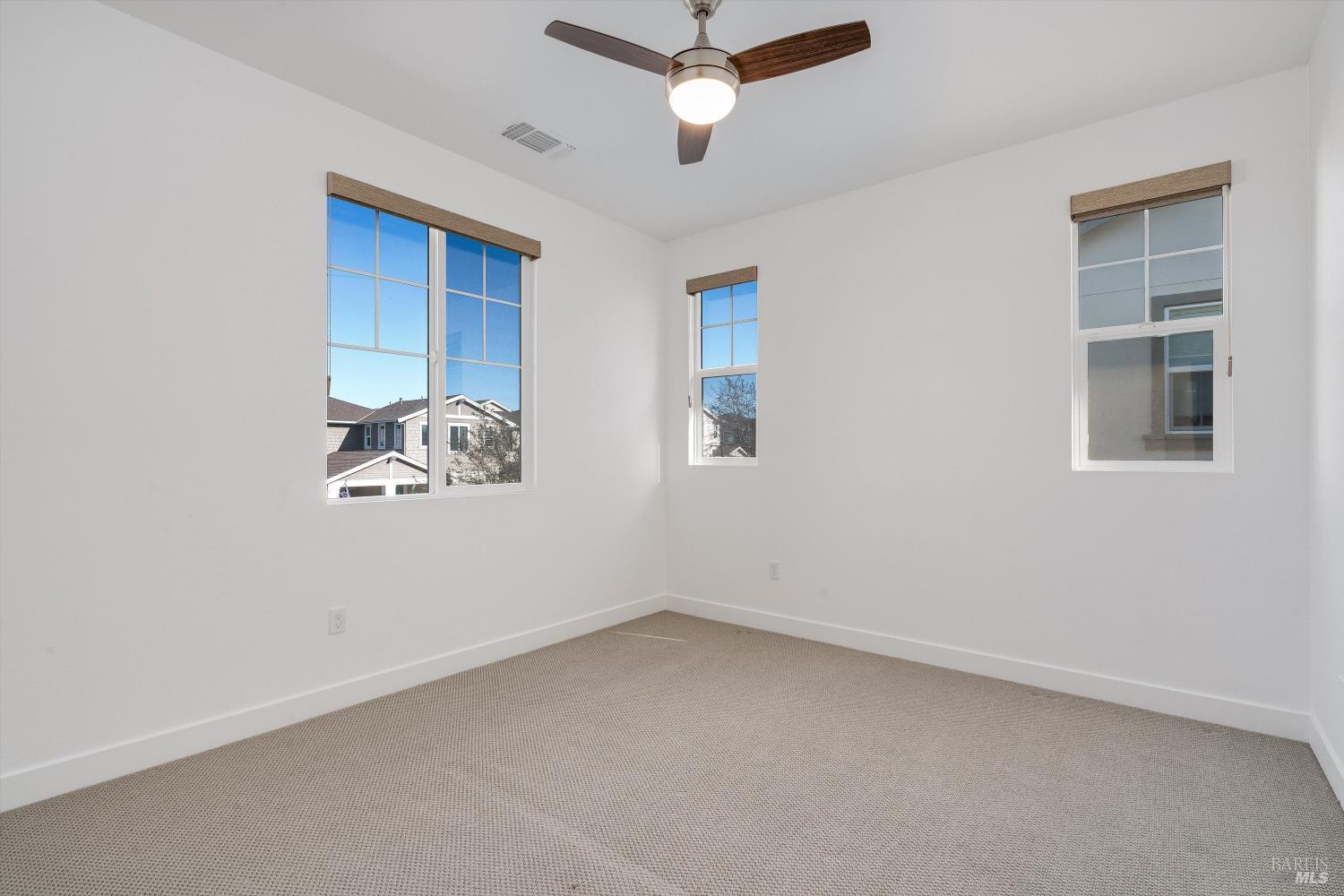 2560 Red Willow Drive Santa Rosa, CA 95403 - Photo 38 of 62 an empty room with windows and ceiling fan