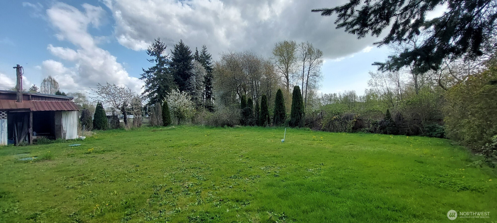 3051 Main Street Custer, WA 98240 - Photo 3 of 12 a view of a garden with a building in the background