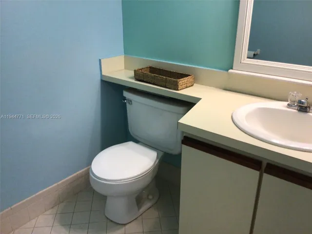 a bathroom with a sink toilet and mirror