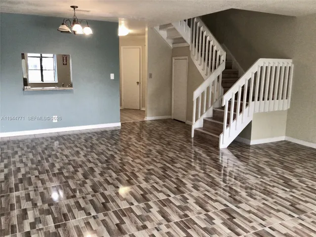 an entryway with staircase and white walls