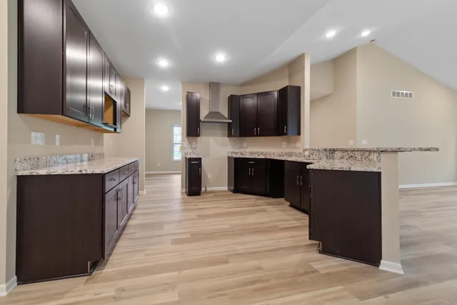 a large kitchen with cabinets and stainless steel appliances