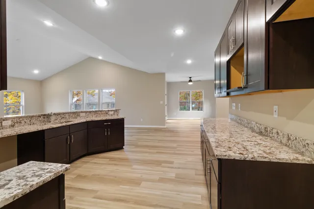 a kitchen with stainless steel appliances granite countertop cabinets and wooden floor