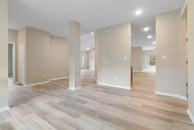 a view of a hallway with wooden floor