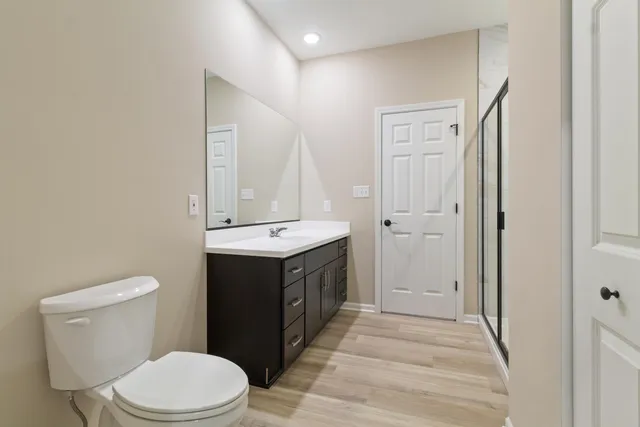 a bathroom with a double vanity sink toilet and shower