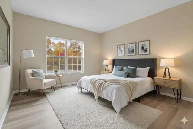 a bedroom with a bed and a large window