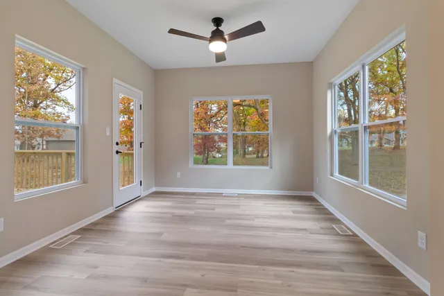 wooden floor in an empty room with a window