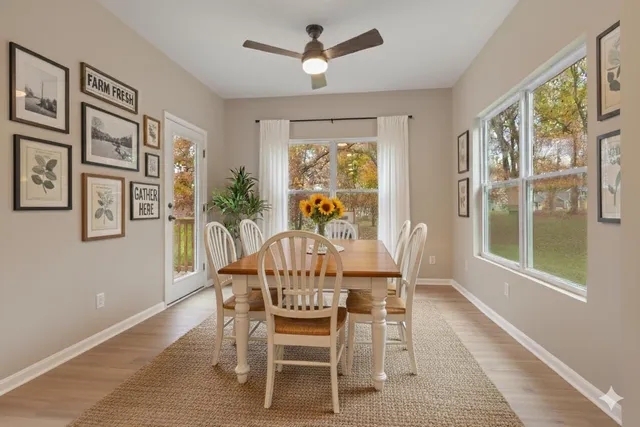 a dining room with furniture a chandelier and wooden floor