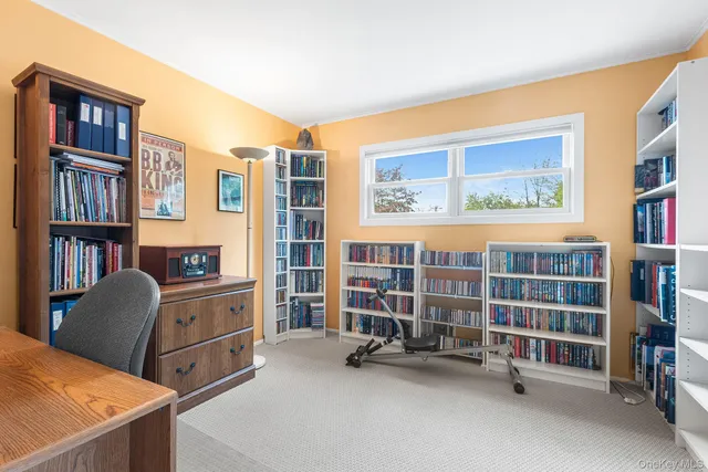 a view of a livingroom with workspace and windows