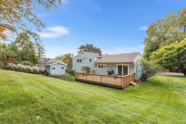 a aerial view of a house with a big yard and large trees