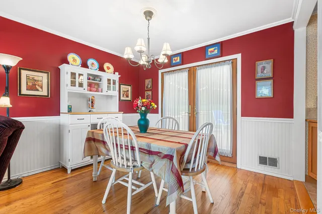 a view of a dining room with furniture and chandelier