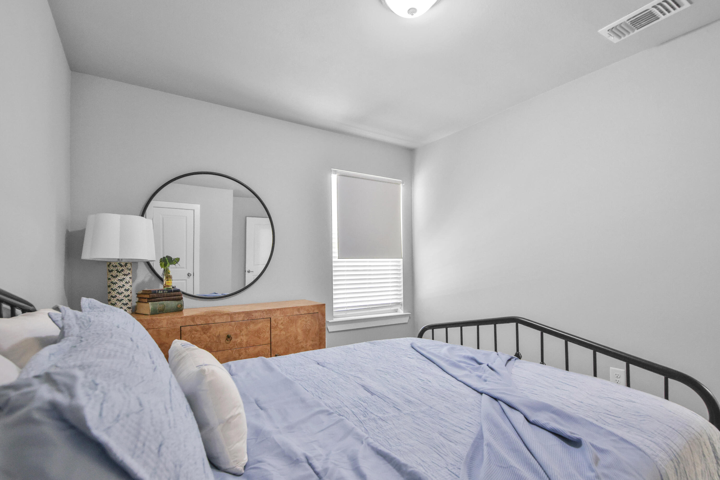 4613 126th Street Lubbock, TX 79424 - Photo 13 of 33 a bedroom with a bed a mirror and dresser