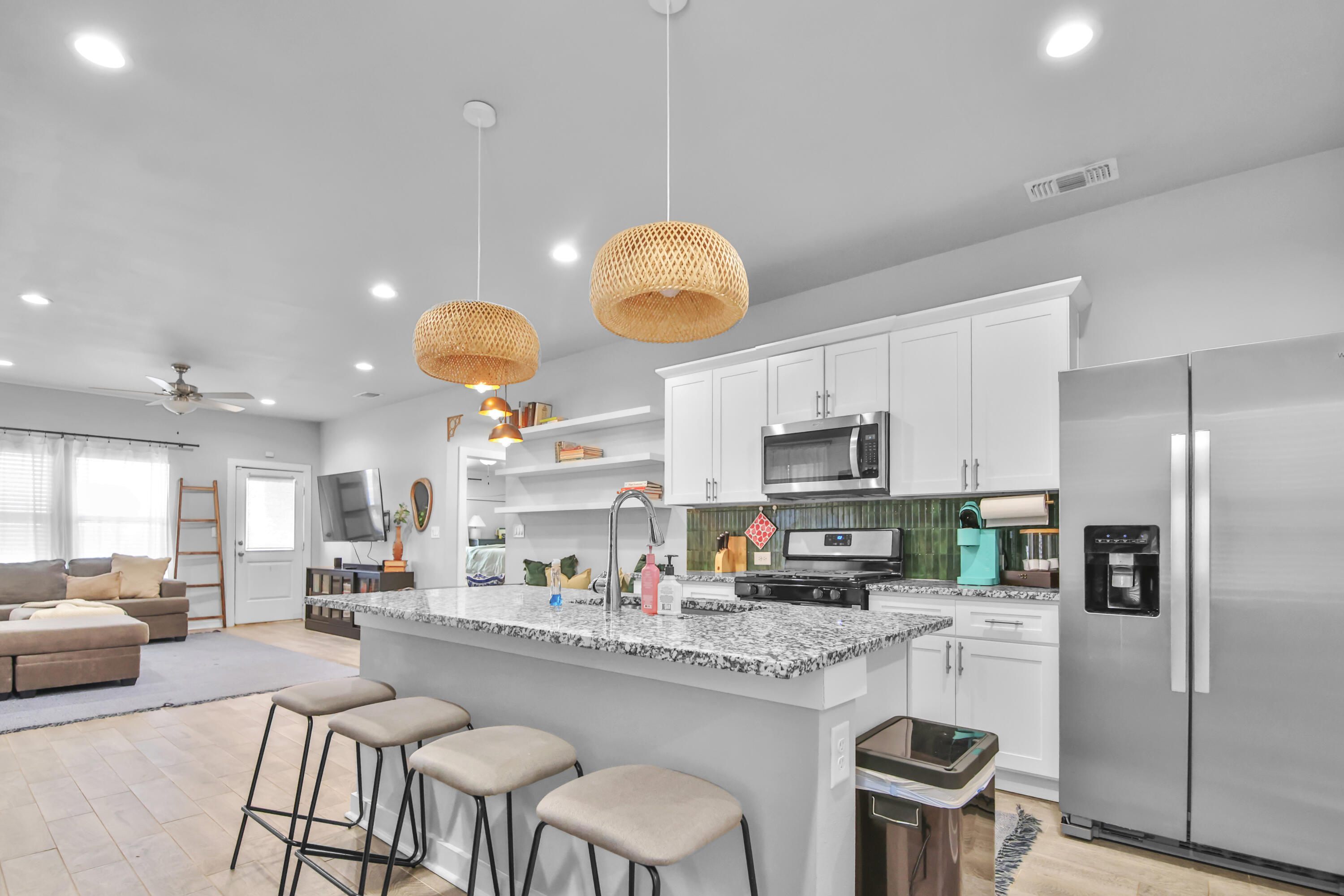 4613 126th Street Lubbock, TX 79424 - Photo 16 of 33 a kitchen with stainless steel appliances granite countertop a sink a stove a refrigerator cabinets and chairs