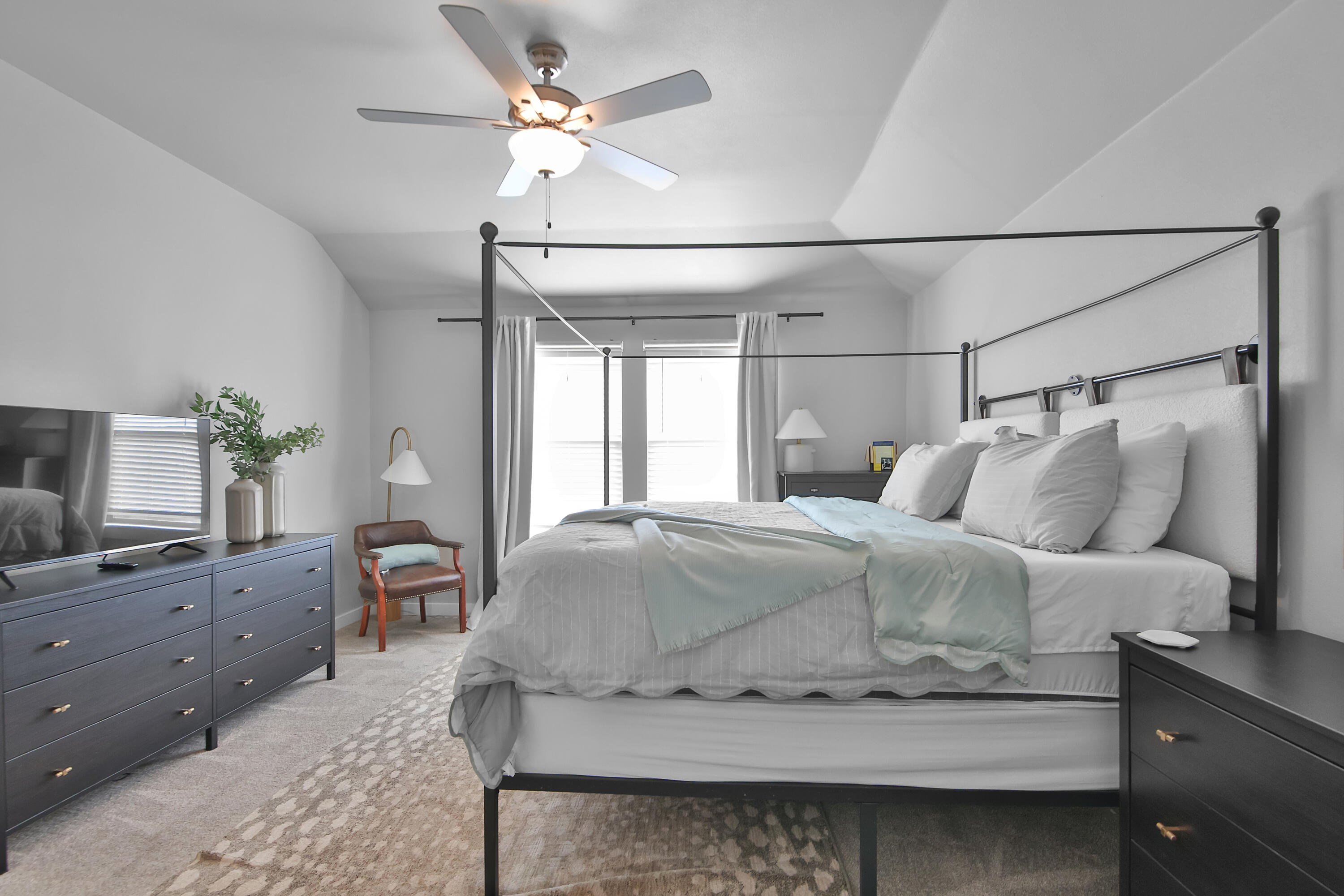 4613 126th Street Lubbock, TX 79424 - Photo 26 of 33 a bedroom with a bed and a chandelier