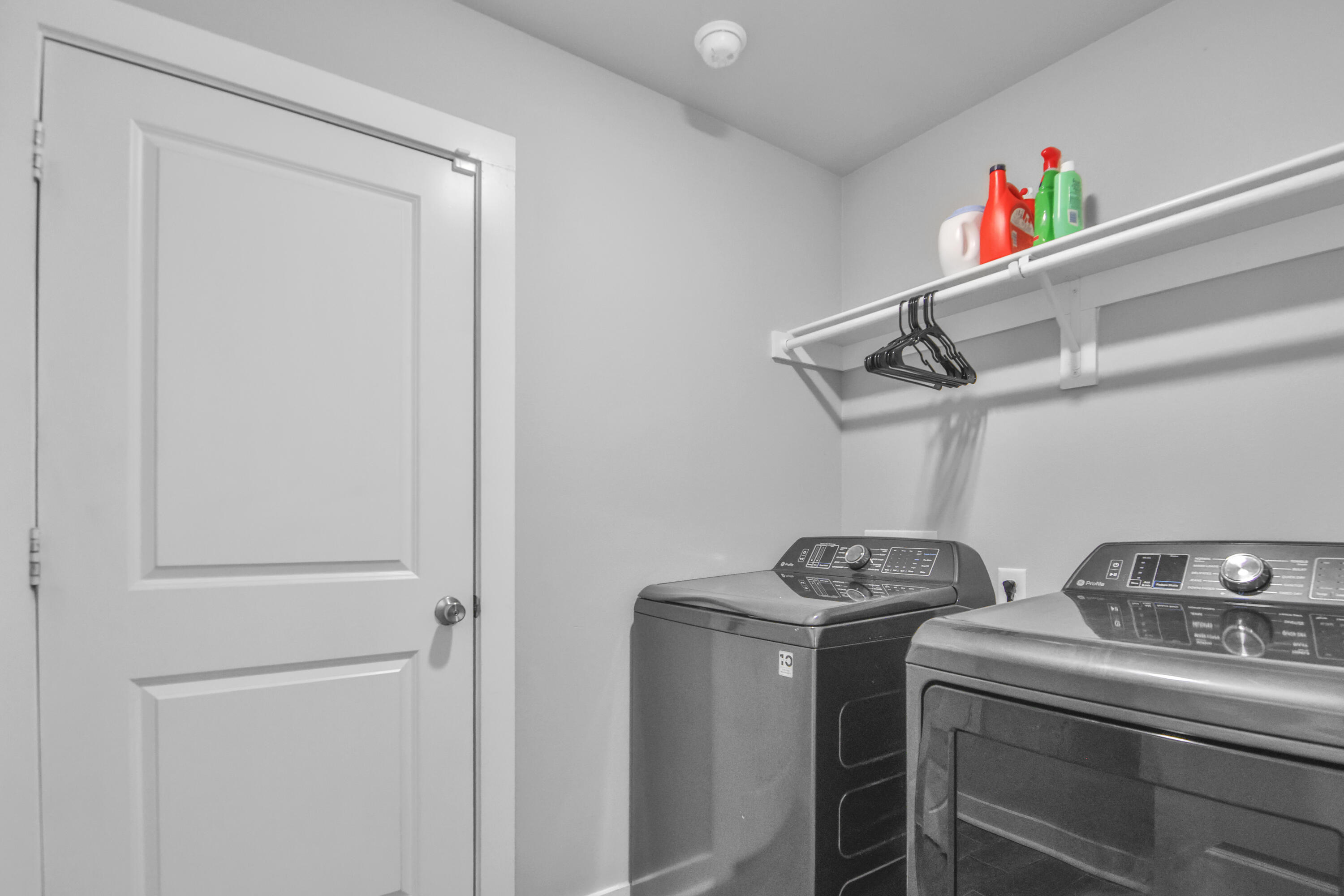 4613 126th Street Lubbock, TX 79424 - Photo 5 of 33 a utility room with dryer washer and empty racks