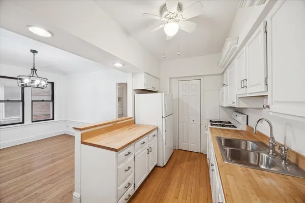 a kitchen with stainless steel appliances a stove sink and cabinets