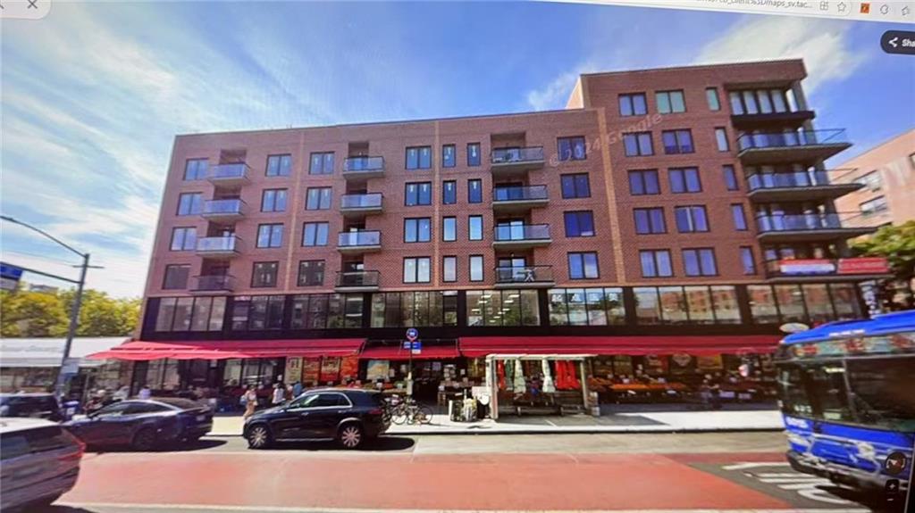 a city street filled with lots of traffic and tall building