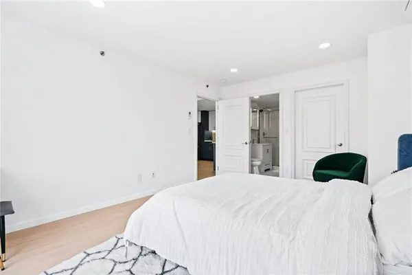 a bedroom with a bed and a cabinets