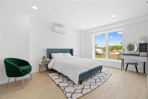 a bedroom with a bed and a lamp next to a window