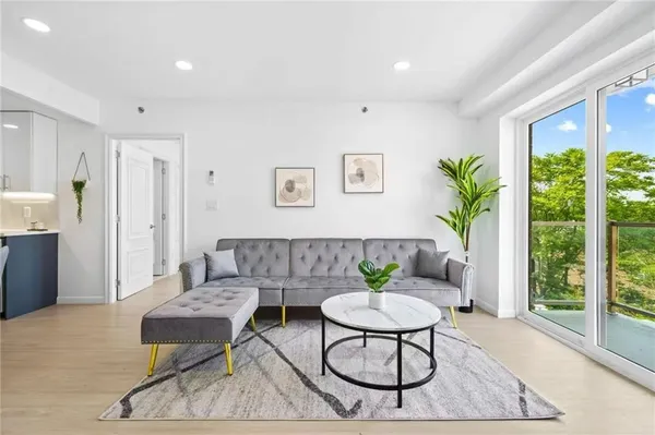 a living room with furniture and a floor to ceiling window