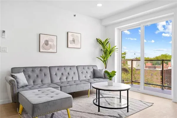 a living room with furniture and wooden floor