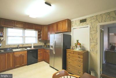 6429 Lignum Street Springfield, VA 22150 - Photo 4 of 29 a kitchen with stainless steel appliances granite countertop a refrigerator sink and cabinets