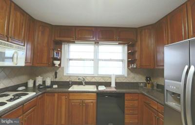 6429 Lignum Street Springfield, VA 22150 - Photo 5 of 29 a kitchen with stainless steel appliances granite countertop a sink stove and refrigerator