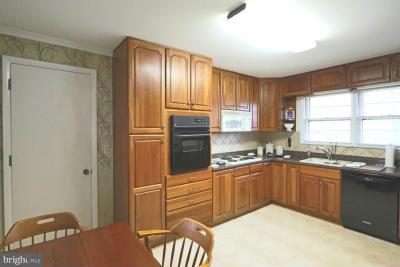 6429 Lignum Street Springfield, VA 22150 - Photo 6 of 29 a kitchen with stainless steel appliances granite countertop a sink stove and refrigerator