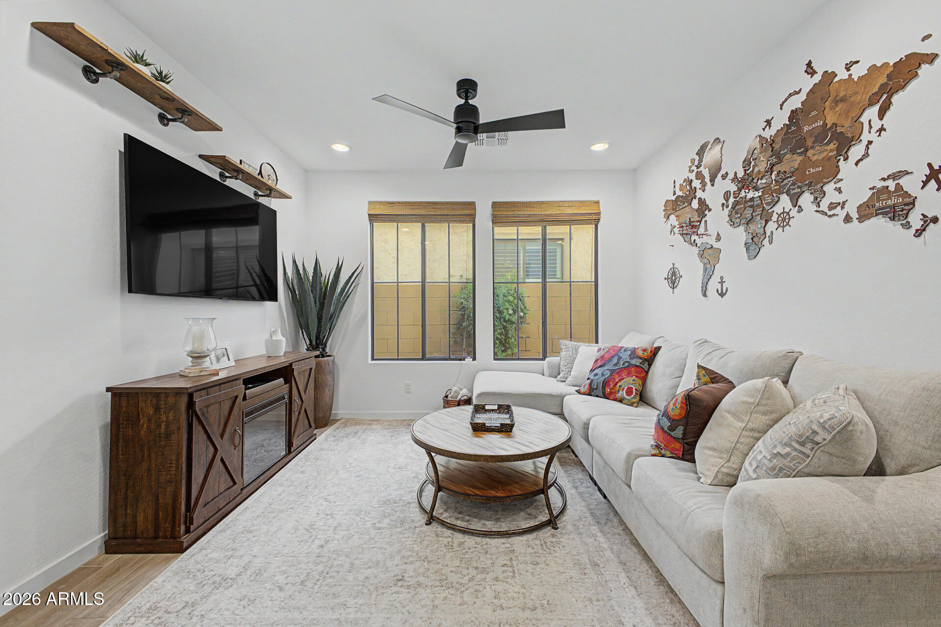 819 West Deer Creek Road Phoenix, AZ 85048 - Photo 17 of 76 a living room with furniture and a flat screen tv