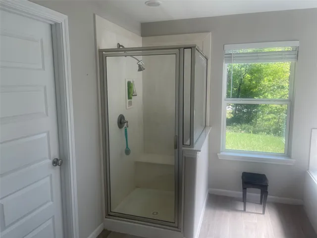 a bathroom with a glass shower door