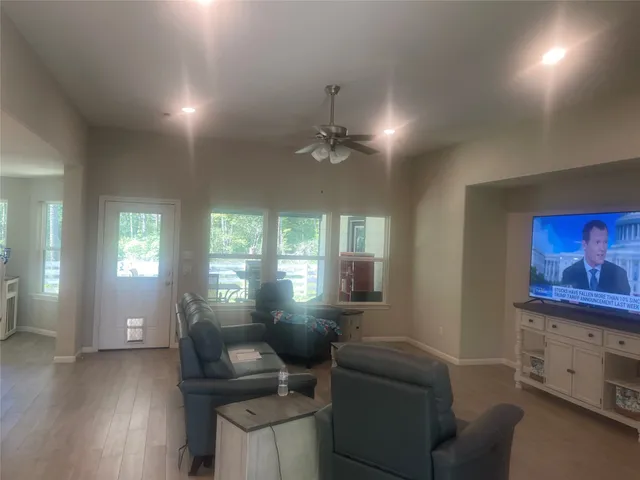 a living room with furniture and a large window