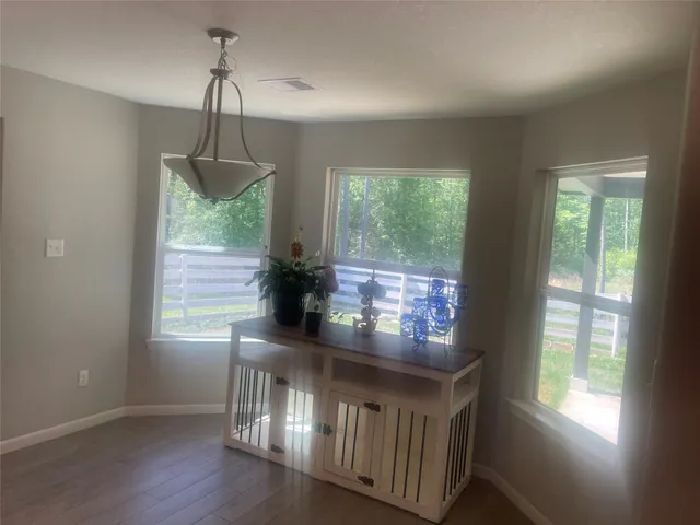 a hallway with windows and wooden floor