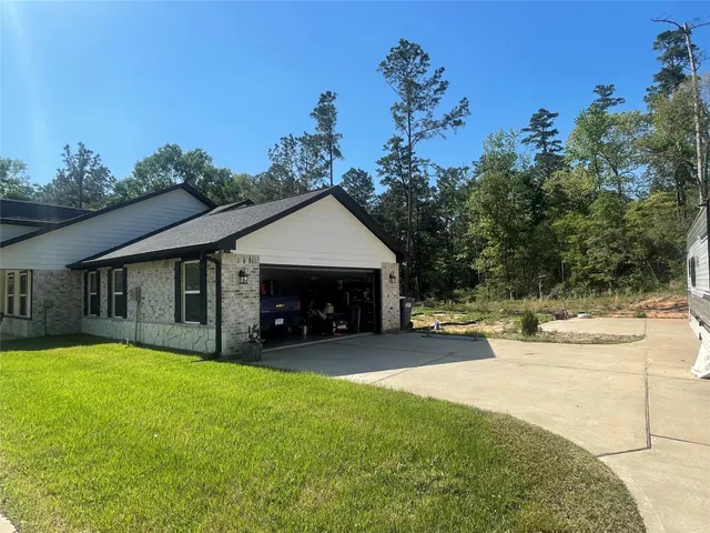 a view of a house with a yard and tree s
