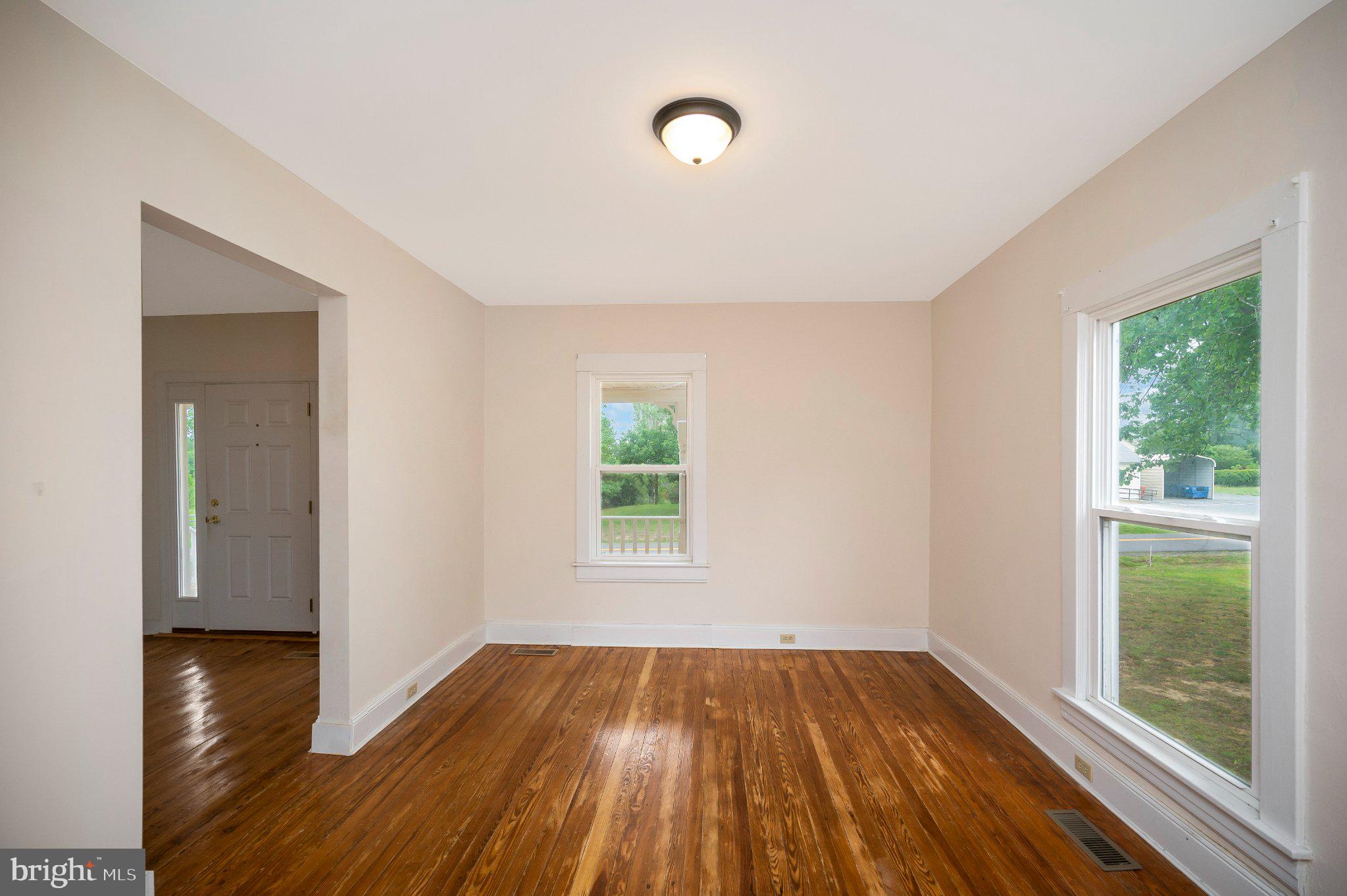 23202 Village Road Unionville, VA 22567 - Photo 12 of 58 a view of an empty room with wooden floor and a window