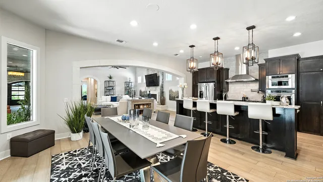 a living room with lots of furniture and kitchen view