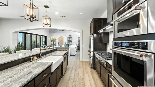 a kitchen with stainless steel appliances granite countertop a stove and a sink