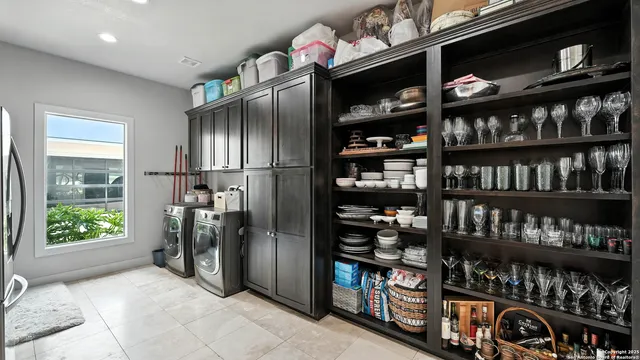 a close view of walk in closet with clothes and shoes